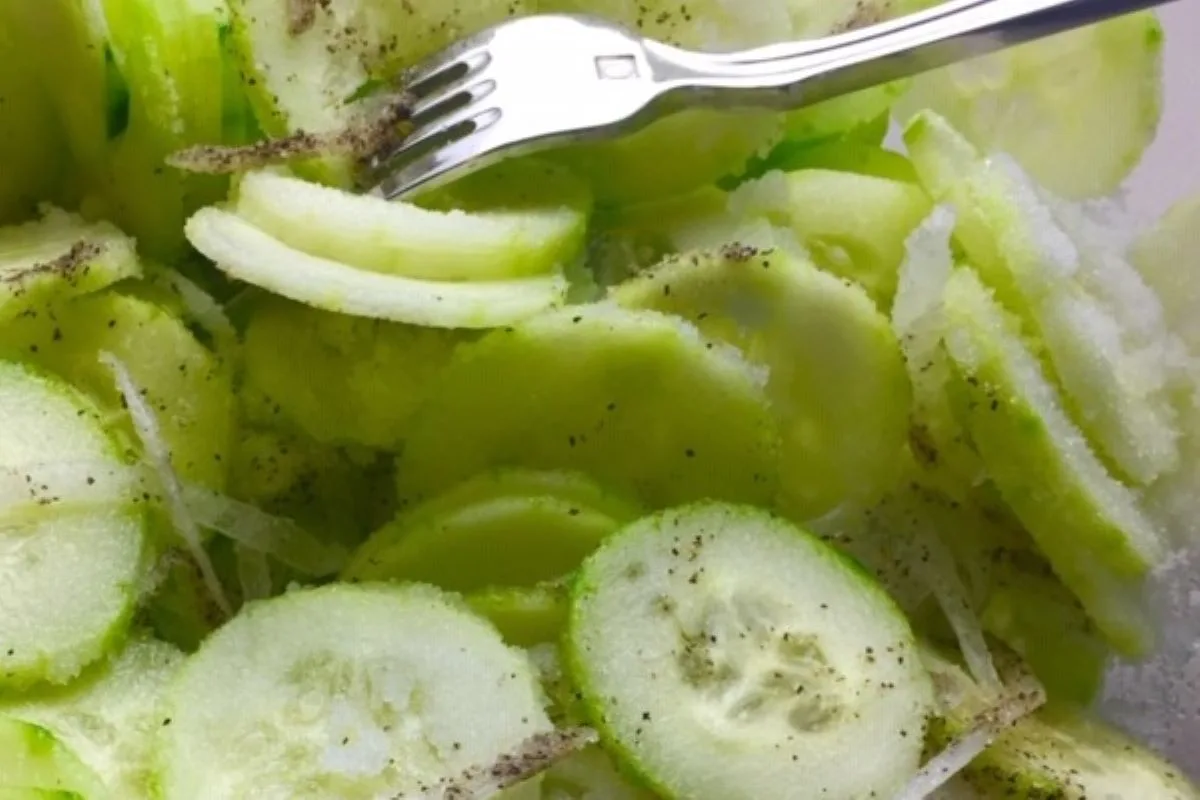 mixing sugar and pepper into cucumber salad