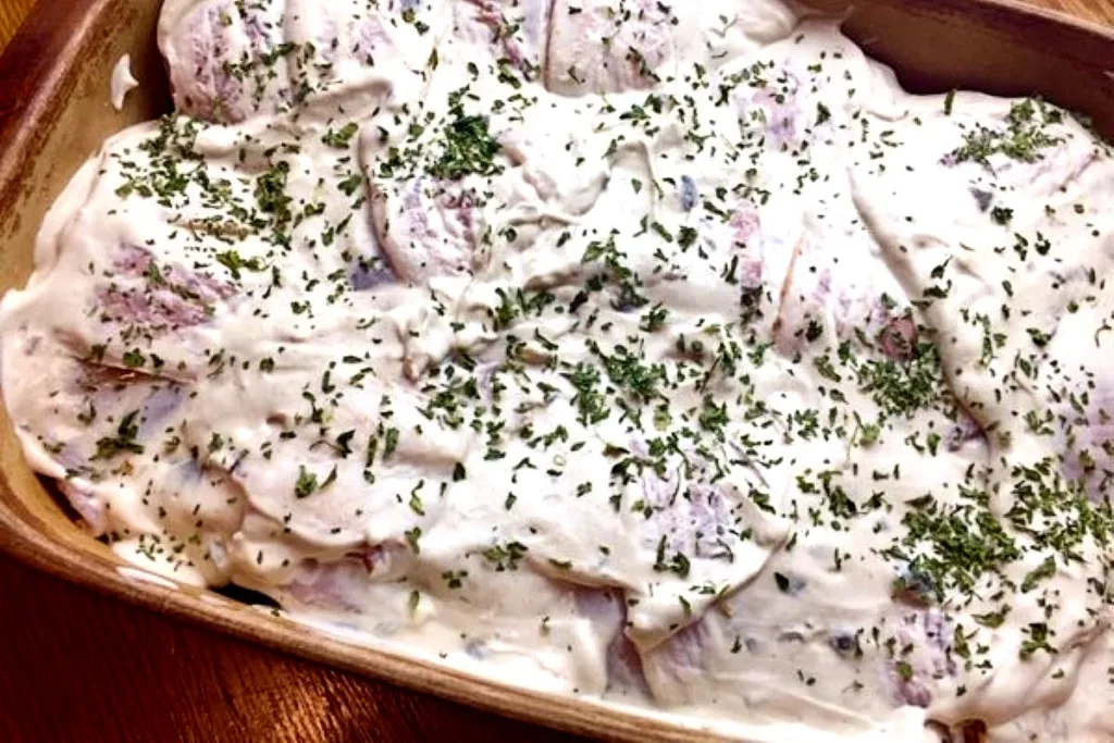 party chicken smothered in sauce and ready to bake
