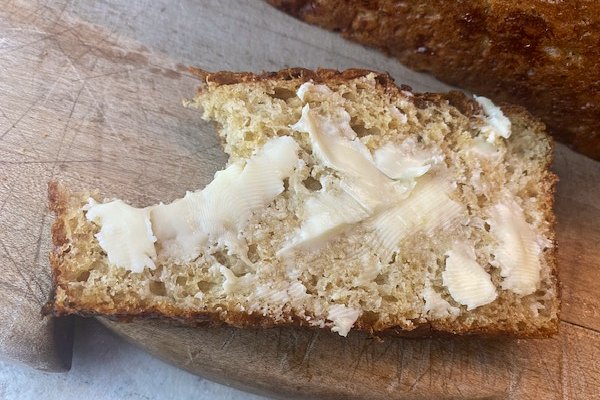 buttered bread with a bite taken
