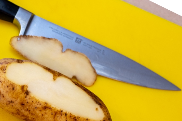 slice off side of potato