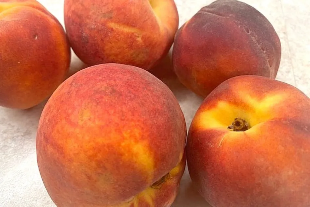 fresh ripe peaches ready to make into a peach pie
