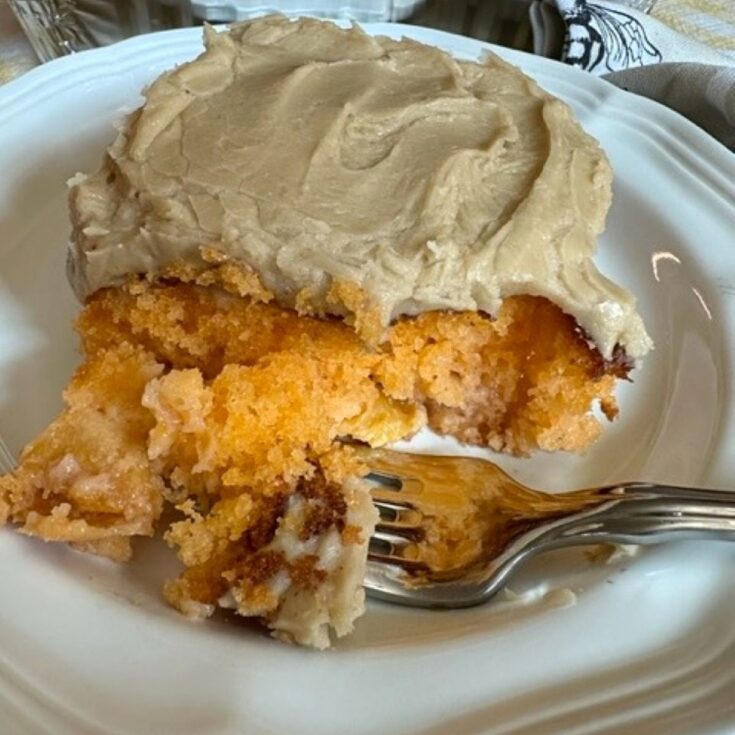 peach cake with caramel buttercream frosting on a plate