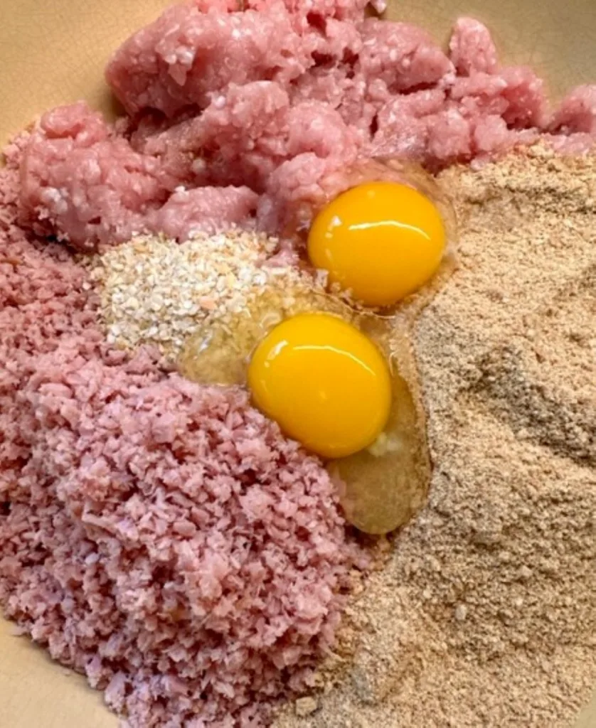 adding ingredients to ham balls