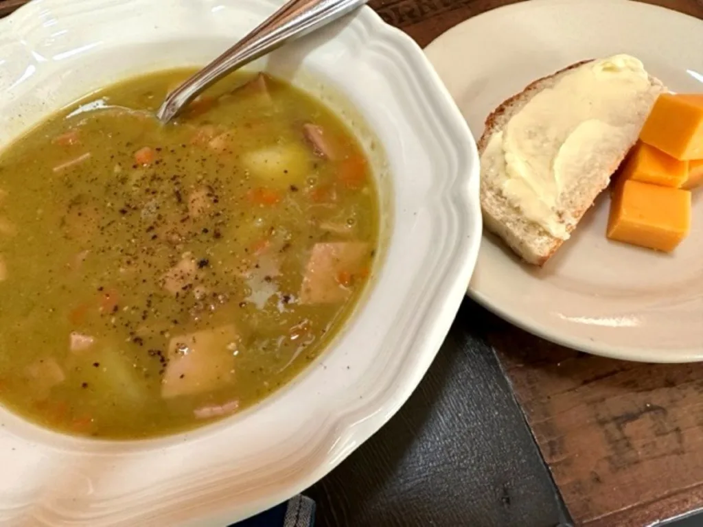 split pea and ham soup served with crusty bread and cheese cubes