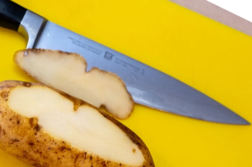 trim one side of the potato