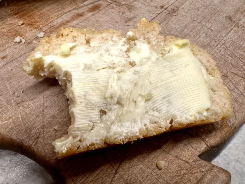 a bite out of a slice of easy beer bread