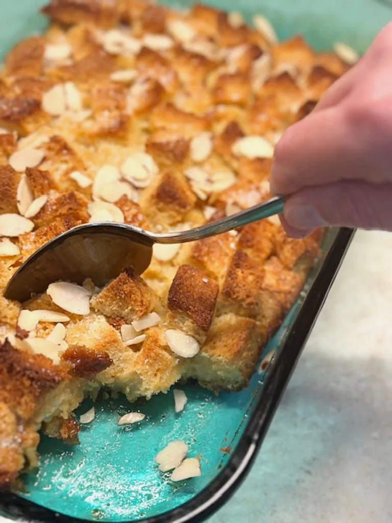 Someone helping themselves to a serving of the best overnight creme brule french toast casserole