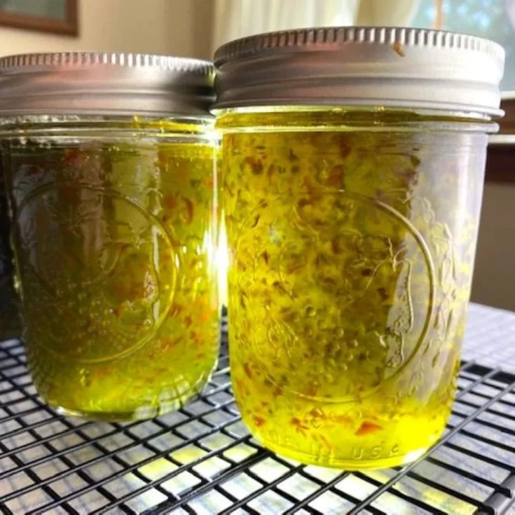 filled jars of jalpeno jelly with sunlight filtering through showing color and texture