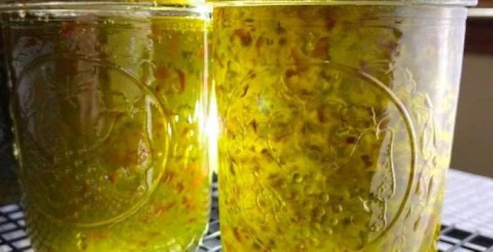 filled jars of jalpeno jelly with sunlight filtering through showing color and texture