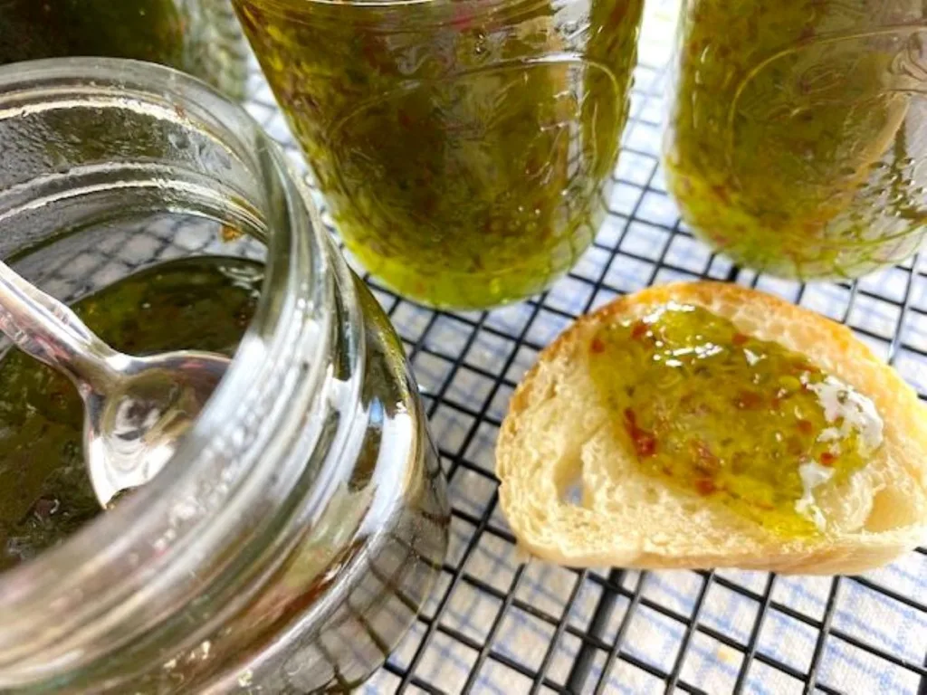 jalapeno jelly and some spread on crusty bread 
