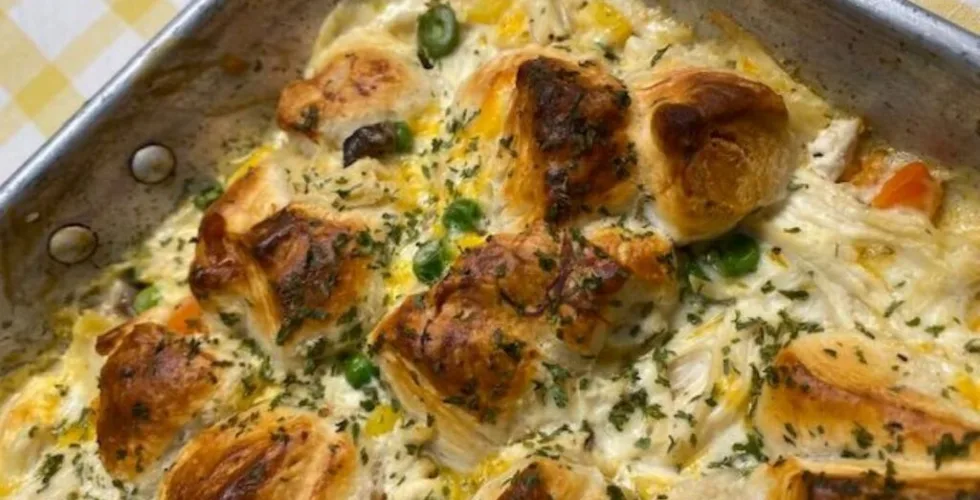 hot bubbly chicken and biscuit pot pie casserole topped with golden brown biscuits