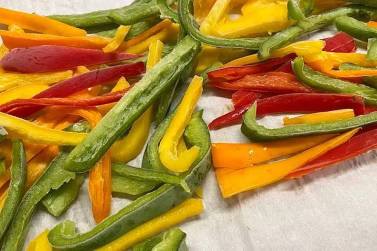 strips of frozen orange, yellow, and green peppers