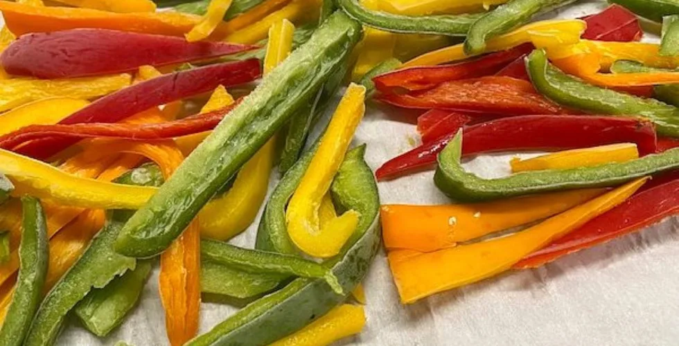 strips of frozen orange, yellow, and green peppers
