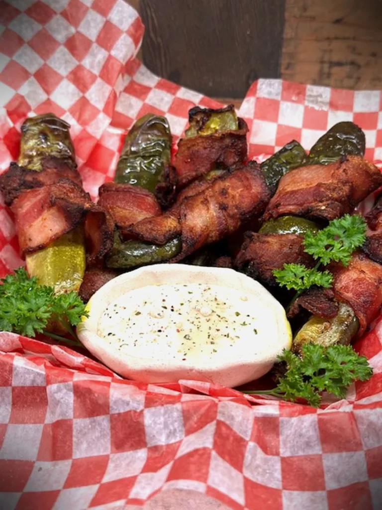 amazing air-fried dill pickles with crispy bacon and served in a basket with Ranch dressing
