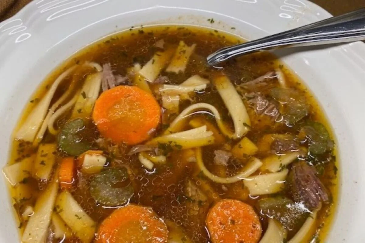 A hearty bowl of homemade beef noodle soup with tender chunks of beef, carrots, and egg noodles in rich broth — cozy comfort food from GB’s Kitchen.